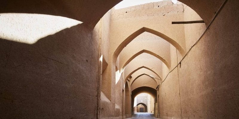 Yazd sabbats display incredible Persian architecture in a desert area creating a shaded area in a hot sunny climate.